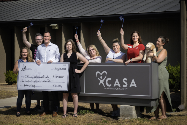 W.D. Kelley Foundation Executive Director Carl Illig, center of check, poses with CASA of Williamson County after funding a new marketing coordinator position. Country of CASA of Williamson County.