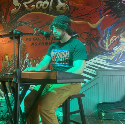 Musician Jay Nava plays on the stage at Roots on the Square. (Photo Courtesy Jay Nava)