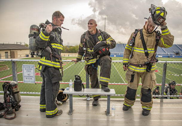Georgetown Fire Department members, including (left to right) firefighter Branden Coughlin, Captain Jason Jeffery and firefighter Justin Barreras, unwind and cool off after completing their climbs.
