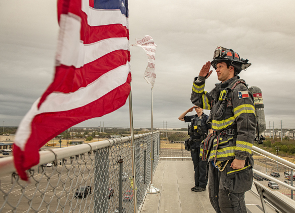 Georgetown Fire Department Captain Aubrey Reeves, front, and Georgetown Police Department officer Ashley Wall, back left, salute after posting  the colors.