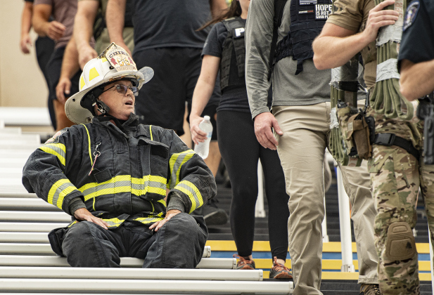 Georgetown Fire Department Battalion Chief Scott Gibson, left, takes a short break before continuing his walk.