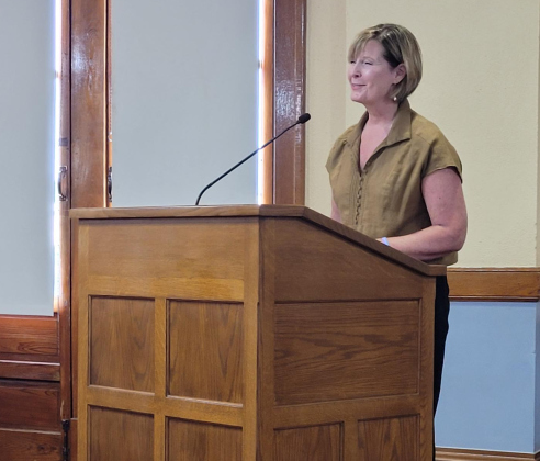 Andrea Richardson from Bluebonnet Trails Community Services shares her organization’s mission with commissioners at their September 12 meeting in the county courthouse. Photo by Nalani Nuylan.