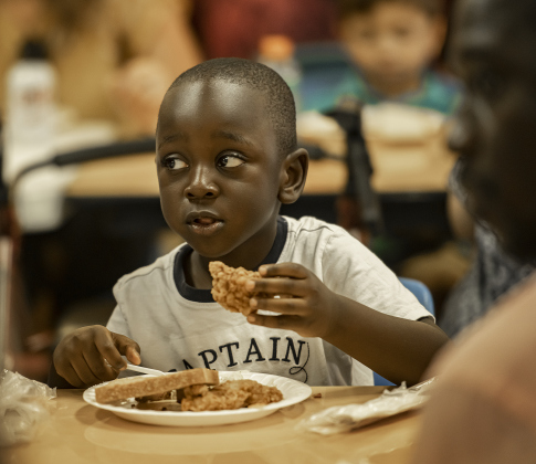 4-year-old Nathan Ngia enjoys a meal with his family.