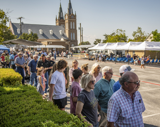 A line of diners forms outside the Parish Activity Center.