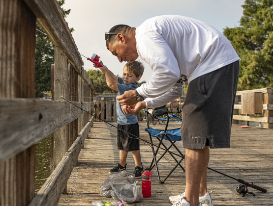 Albert Arzola guides his son Jace, 3.
