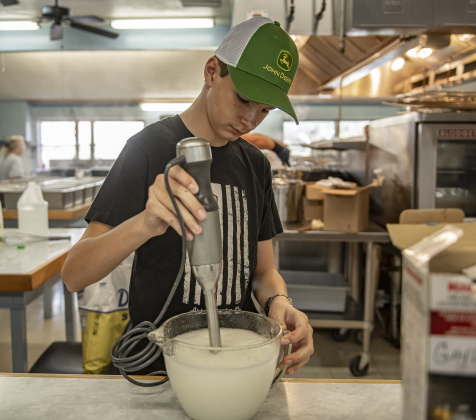 13-year-old Luke Nemec prepares dressing for slaw  in the parish hall kitchen.