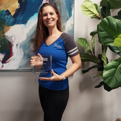 Marissa A. Austin, chief executive officer of Court Appointed Special Advocates of Williamson County, poses the 2023 Impact Award from the Central Texas Community Foundation. Photo courtesy of CASA of Williamson County.