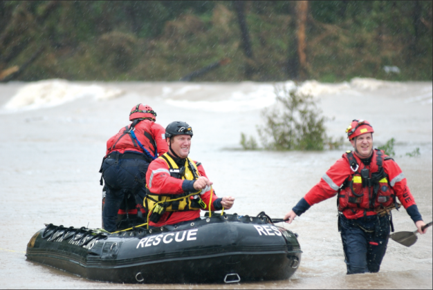 Travis County Emergency Paramedics maneuver a rescue boat in the San Gabriel River off Highway 29 during the 2010 floods. Sun Archive Photo.
