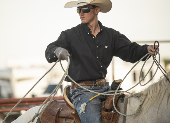 18-year-old Tyler Simpson, riding his horse named Waylon, gets ready to compete in Senior Breakaway Roping.