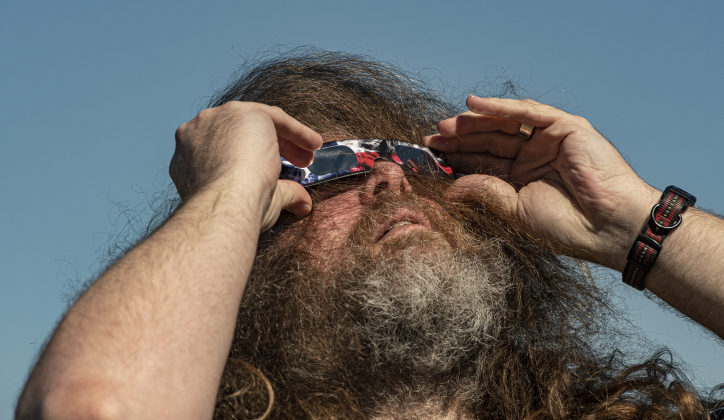 Chris Bruce watches the annular eclipse  during a Saturday, October 14, 2023 gathering at Berry Springs Parks &amp; Preserve,  hosted by Friends of Berry Springs Park.  An annular eclipse occurs when the moon gets between the earth and sun.  The eclipse's visibility was approximately 89% in the Austin area.