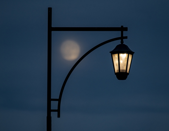 A Waxing Gibbous moon, at 97.1% visibility, shines over Clark Street in downtown Bartlett on Wednesday evening, September 27, 2023.