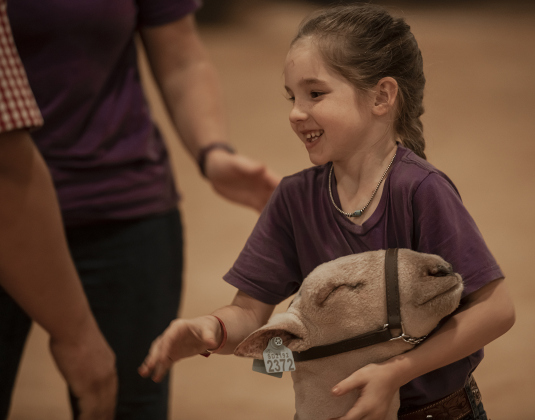 7-year-old Carlie Stiles of Rio Vista, Texas is all smiles after she and her sheep named Ferdinand won a ribbon during the Chisholm Trail Showdown Breeding Sheep Show, held Thursday, October 26, 2023 at the Williamson County Expo Center during the Williamson County Fair and Rodeo.
