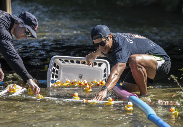 Georgetown Fire Department Dive Team members Will Henwood, left, and Jonathan Marquez, right, assisted in collecting rubber ducks at the finish line  during the Duck Races event coordinated by the American Association of University Women on Saturday, September 24, 2022 at San Gabriel Park.  The A.A.U.W. Duck Races are a fundraiser to provide scholarships for area students.  Six  race heats were held, with 50 rubber ducks launched into the water each time.