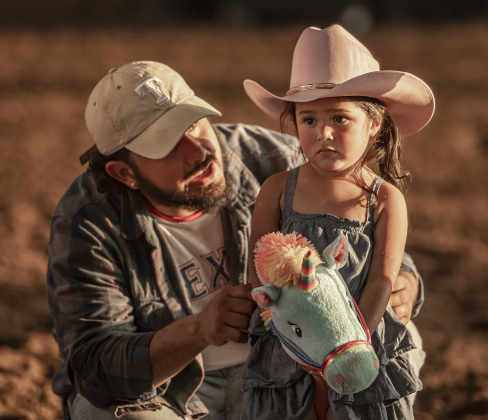 Edward Cosme gives encouragement to his daughter Edie, 3, during the stick horse competition on Wednesday, October 25, 2023, the opening day of the Williamson County Fair and Rodeo, held at the Williamson County Expo Center through October 28th.   Dad said Edie was a bit scared of the "clown," the fair mascot, Wilco Willie.  Despite those fears, Edie was one of the top winners.