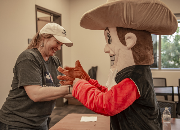 Kelley Hernandez, left, the director of this year's Williamson County Fair and Rodeo, helps the fair's Wilco Willie mascot, played by 16-year-old TJ Kirchner back into his costume after a rest break  on Wednesday, October 25, 2023, the opening day of the Williamson County Fair and Rodeo, held at the Williamson County Expo Center through October 28th.