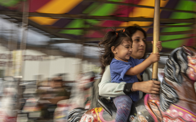 Diana Preshad and her daughter Vaani, 2, have fun together during a merry-go-round ride together  on Wednesday, October 25, 2023, the opening day of the Williamson County Fair and Rodeo, held at the Williamson County Expo Center through October 28th.