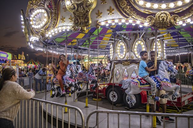 Families enjoy a midway ride on a carousel merry-go-round  on Wednesday, October 25, 2023, the opening day of the Williamson County Fair and Rodeo, held at the Williamson County Expo Center through October 28th.