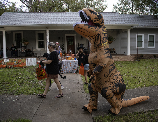 Leonel Sanchez was T-Rex on  Halloween night along Main Street in Old Town on Monday, October 31, 2022.   Photo by Andy Sharp.
