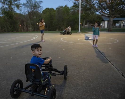4-year-old Ricardo Rodriguez enjoys driving a peddle cart provided by the Georgetown Y.M.C.A. during a National Night Out event held at San Jose Park.