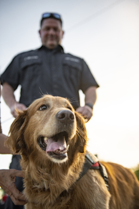 Georgetown Fire Department Deputy Fire Marshall Jonathan Gilliam is shown with Koda, the department's official fire dog  during a National Night Out event held at San Jose Park.