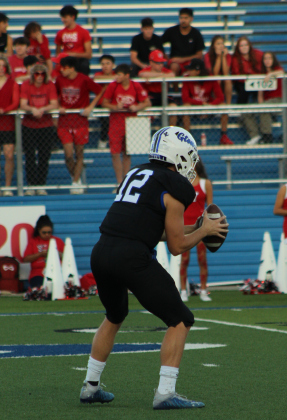 Georgetown Eagles quarterback Noah Booras practices throwing the football before the game.
