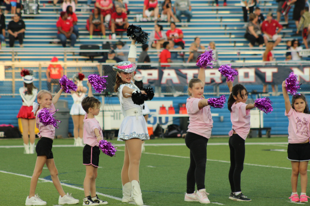Little dancers are taught a pom routine by a Georgetown Goergette Captian. Photo by Nalani Nuylan.