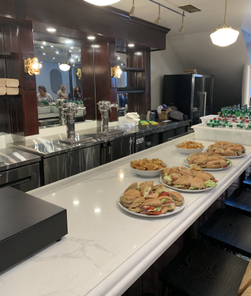 Snacks were set out for visitors of the ribbon cutting ceremony at the first floor bar, which also has barstools. (Photo by Kaitlyn Wilkes)