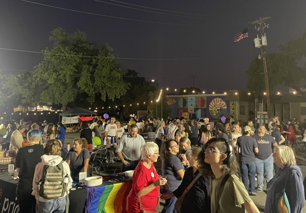 The crowd gathers in the library’s parking lot around vendor tables at the Coming Out Block Party. (Photo by Nicolas Cicale)