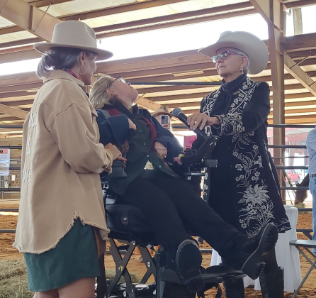 Rebecca “Hunter” Adkins, center, is the second recipient of the Dr. Barbara Brightwell Courage & Grit Award. CEO of ROCK Dr. Nancy Krenek, left, and MC Patti Colbert ask Ms. Adkins how she feels about receiving the award. Photo by Nalani Nuylan.