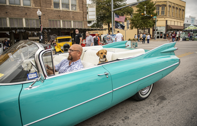 Yanni Funk and his dog Connor relax in his 1959 Cadillac convertible, an entry in Taylor's Main Street Car Show on Saturday, October 28, 2023.