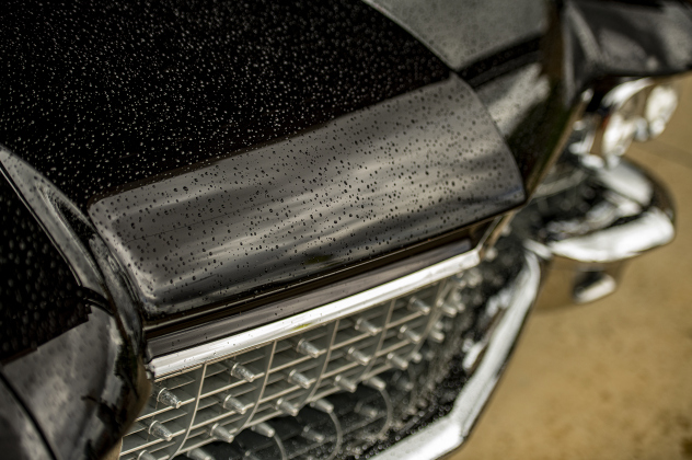 Raindrops fall on the hood and front grill of a 1960 Cadillac Coupe de Ville owned by Reggie and Johanna Hill of Georgetown during Taylor's Main Street Car Show on Saturday, October 28, 2023.