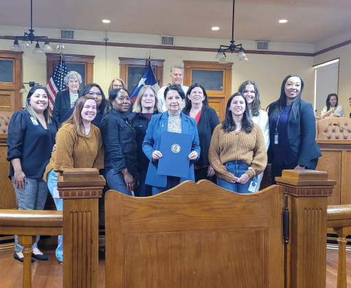 The Williamson County Commissioner's court and members from Tree of Angels pose for a photo after the commissioners voted to make December 5 Tree of Angels Day for the county. Photo by Nalani Nuylan.