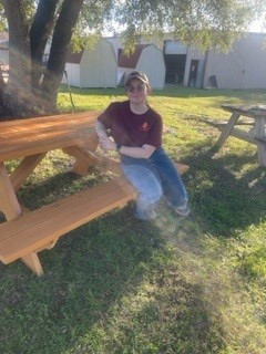 Maria Combes, 16, sits on a picnic table she constructed for her American Heritage Girl Stars and Stripes Award. Photo courtesy of Jennifer Morgan.