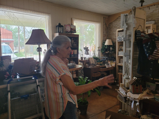 Debbie Wendeler gives a tour of the Fourth of July section of her gift shop. Originally the Bartlett post office, she gets the supplies for the store in Dallas. Photo by Nalani Nuylan.