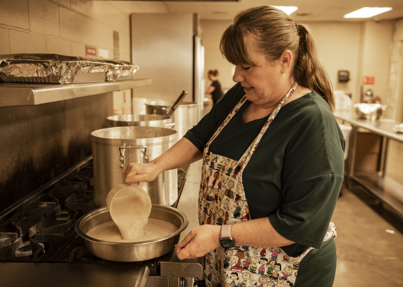 Johnnie Kovar helps with meal preparation during the Community Thanksgiving, held at the Georgetown Community Center in San Gabriel Park on Thursday, November 23, 2023.