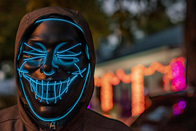 Roger Lopez, with his light-filled mask, has Halloween night fun along  Main Street in Old Town on Tuesday, October 31, 2023.