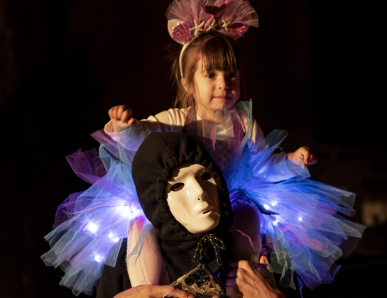 2-year-old Savannah Gonzalez gets a ride on the shoulders of her uncle David Ruiz as they take in the sights of Halloween night  along Main Street in Old Town on Tuesday, October 31, 2023.
