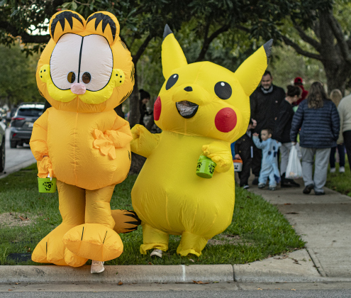 Elise Hernandez, left, as Garfield, and Emily Camarena, as Pikachu, a Pokemon character, are pictured  along Main Street in Old Town on Tuesday, October 31, 2023.