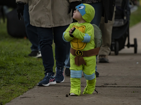 15-month-old Frankie Flores, Jr. enjoys time  with his family along Main Street in Old Town on Tuesday, October 31, 2023.