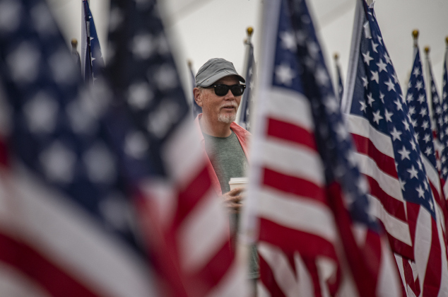 Richard Daniel is surrounded by a sea of color as he admires  American flags at the Field of Honor on Saturday, November 4, 2023.