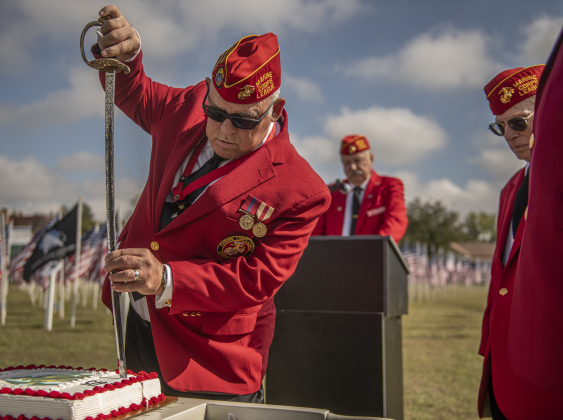 Marine Corps veteran Kent Schulz-Behrend uses a ceremonial sword to cut a cake commemorating the 248th birthday of the U.S. Marine Corps  at the Field of Honor on Saturday, November 4, 2023.