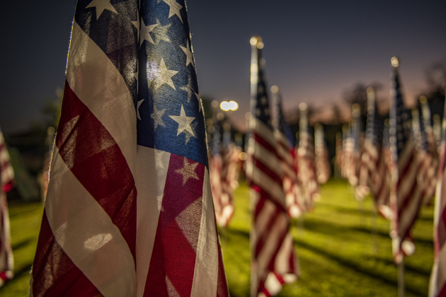 American flags adorn a field behind the Hammerlun Center for Leadership and Learning on Friday, November 3, 2023, the evening before the official opening of the 7th Annual Field of Honor.