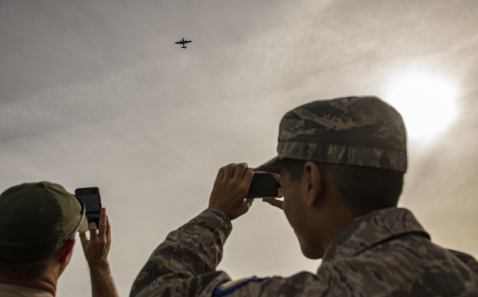 Attendees take photos of the Commemorative Air Force B-25 Devil Dog flyover during the Field of Honor opening ceremonies on Sunday, November 5, 2023.