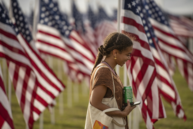 Attendee Talitha Brant walks through the flags at the Field of Honor on Sunday, November 5, 2023.