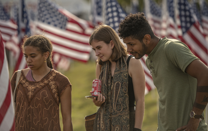 Friends (left to right) Talitha Brant, Eliana Kernodle and Carlos DeJesus walk through the rows of flags  at the Field of Honor on Sunday, November 5, 2023.