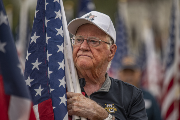 Gary Keilman prepares to place American flags at the Field of Honor on Saturday, November 4, 2023.