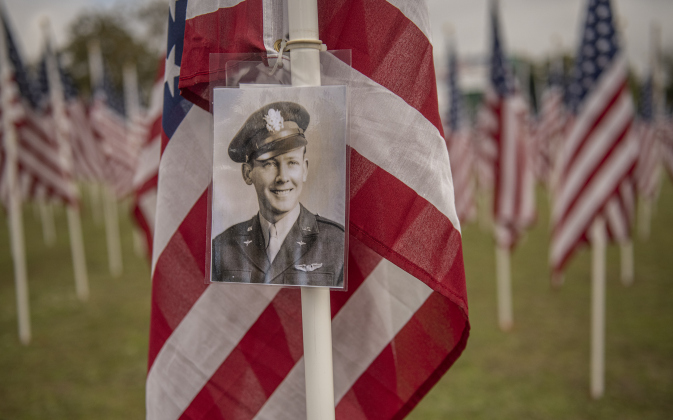 A photograph of World War II Army Air Corps member Ed Olson, who died in 2018, was placed on a flag honoring him by his son Larry Olson  at the Field of Honor on Saturday, November 4, 2023.  Ed Olson was with the 384th Bombardment Group. 