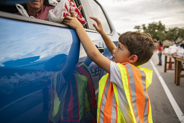 9-year-old Harrison Hodgkins helps deliver sausage plates and sausages during the 51st Annual Wurstbraten at Zion Lutheran Church on Monday, November 6, 2023. 