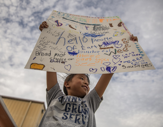 7-year-old Yenzi Bachman joined other kids attracting attendees with posters advertising food offerings during the 51st Annual Wurstbraten at Zion Lutheran Church on Monday, November 6, 2023.