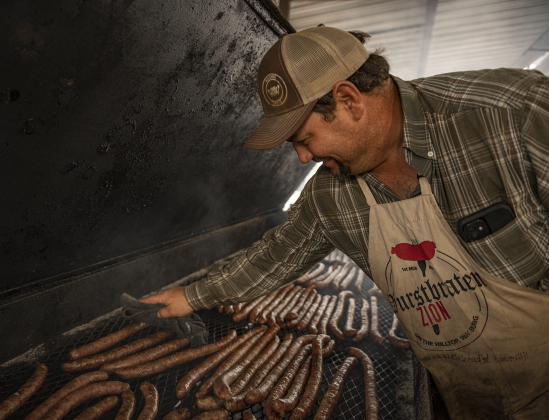 John Faske keeps a close watch on sausages in a smoking pit  during the 51st Annual Wurstbraten at Zion Lutheran Church on Monday, November 6, 2023.